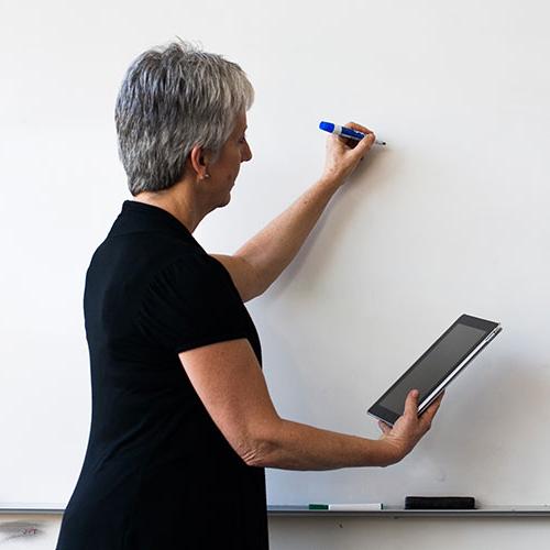teacher using a tablet in the classroom